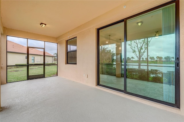 unfurnished sunroom featuring a healthy amount of sunlight and a water view