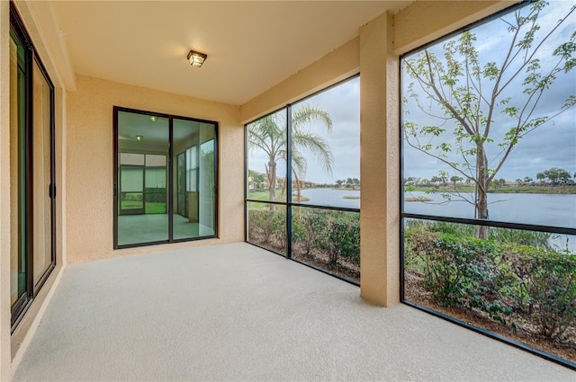 unfurnished sunroom with a water view