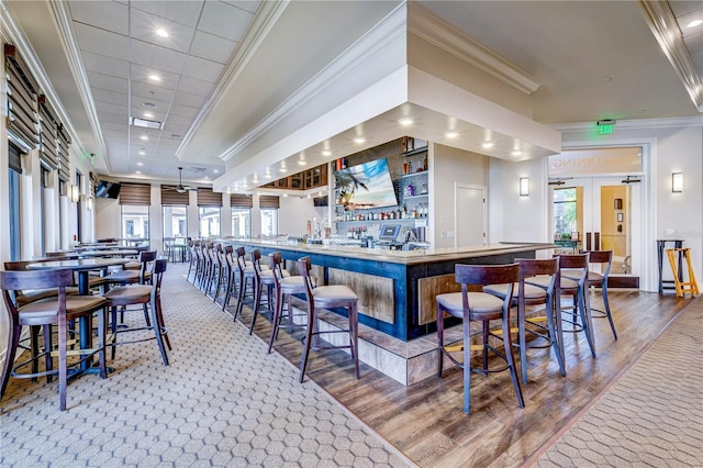 bar featuring wood-type flooring and ornamental molding