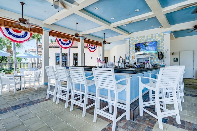 view of patio / terrace featuring ceiling fan and a bar