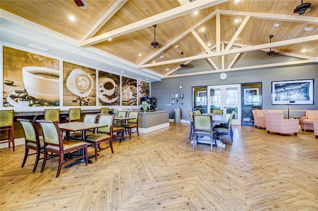 dining space with high vaulted ceiling and wooden ceiling