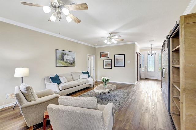 living room with ornamental molding, hardwood / wood-style floors, and ceiling fan