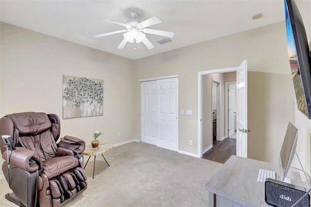 sitting room with carpet floors and ceiling fan