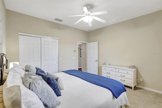 carpeted bedroom with a closet and ceiling fan