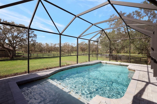 view of pool with glass enclosure and a lawn