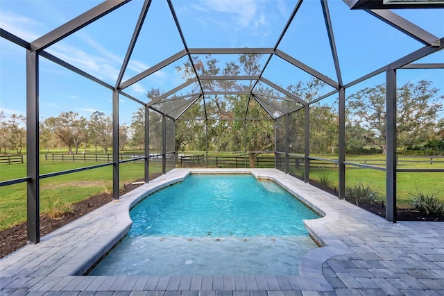 view of pool with a yard, a patio area, and a lanai