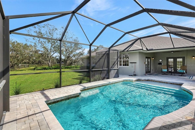 view of swimming pool with a lawn, french doors, a patio area, and glass enclosure