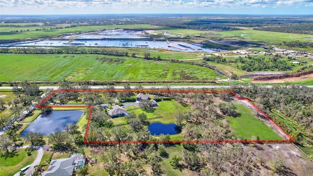 drone / aerial view featuring a water view and a rural view