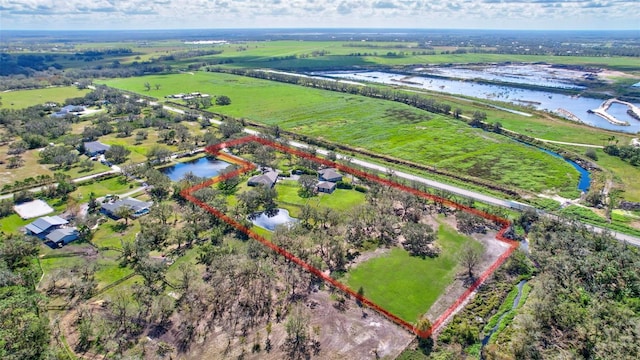 birds eye view of property with a rural view and a water view