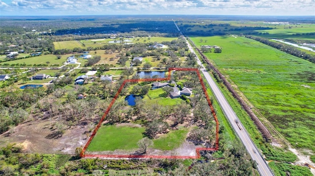 birds eye view of property with a rural view and a water view