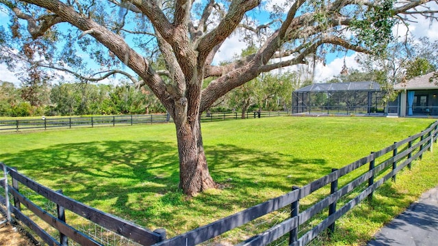 view of yard featuring a lanai and a rural view