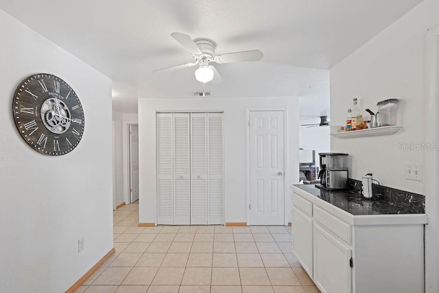 kitchen featuring white cabinetry and light tile patterned flooring