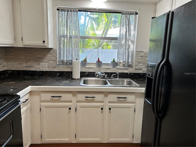 kitchen with sink, tasteful backsplash, white cabinetry, and black appliances