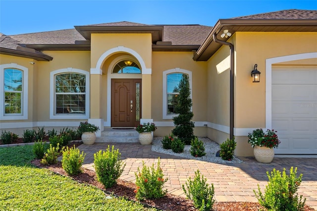 view of exterior entry with a garage