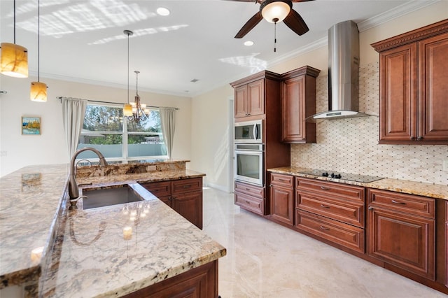 kitchen with appliances with stainless steel finishes, wall chimney exhaust hood, crown molding, sink, and hanging light fixtures