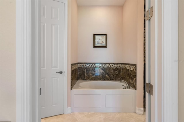 bathroom featuring tile patterned flooring and a tub