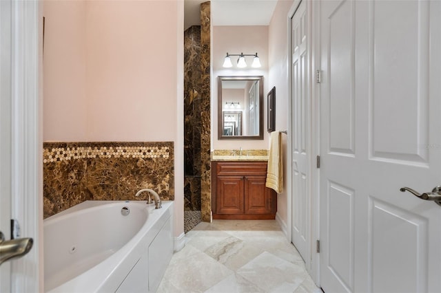 bathroom featuring vanity and a bath