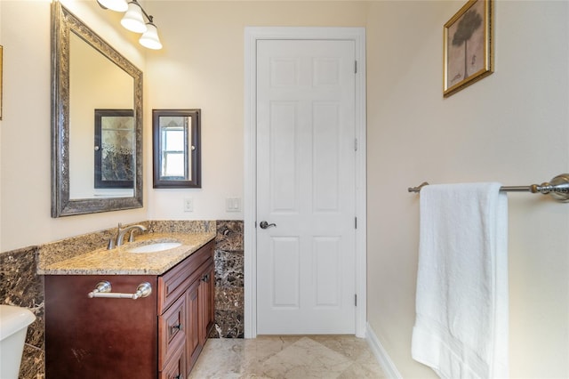 bathroom featuring vanity and toilet