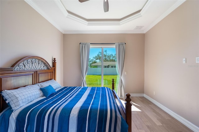 bedroom with a tray ceiling, ceiling fan, crown molding, and access to outside