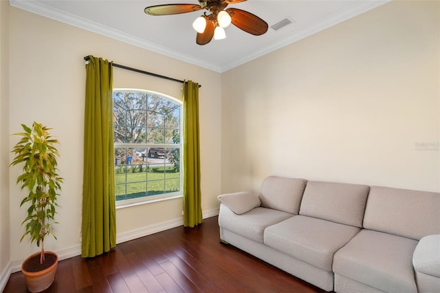 living room with ceiling fan, a healthy amount of sunlight, dark hardwood / wood-style flooring, and crown molding