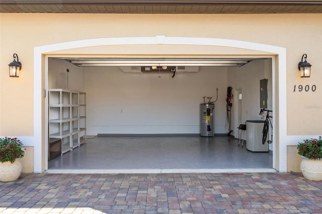 garage featuring electric panel and water heater