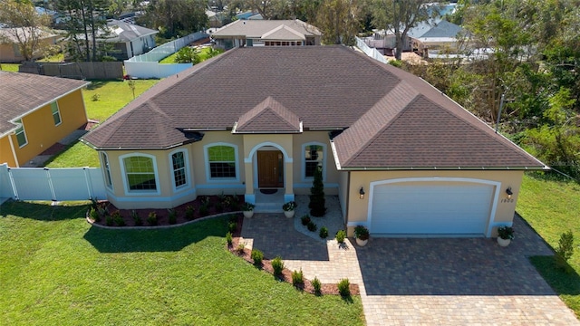 view of front of property featuring a garage and a front lawn