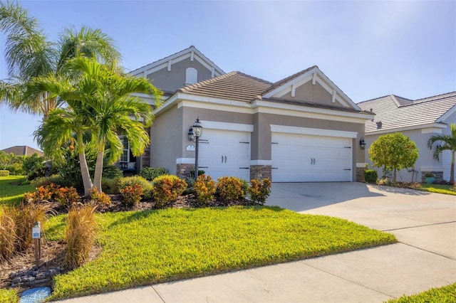 view of front of house with a garage and a front yard