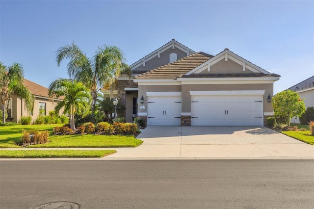 view of front of property featuring a garage and a front yard