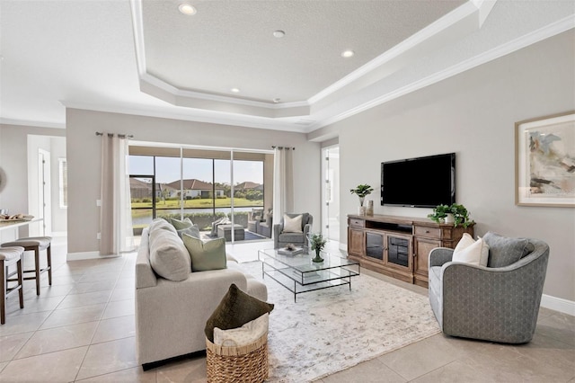 living room featuring crown molding, a textured ceiling, light tile patterned floors, and a raised ceiling