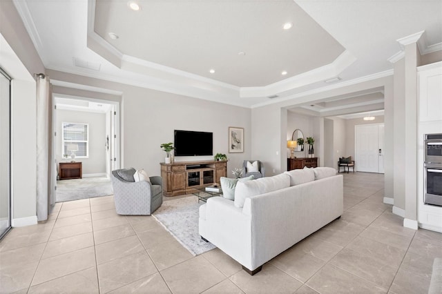 living room with a tray ceiling and crown molding