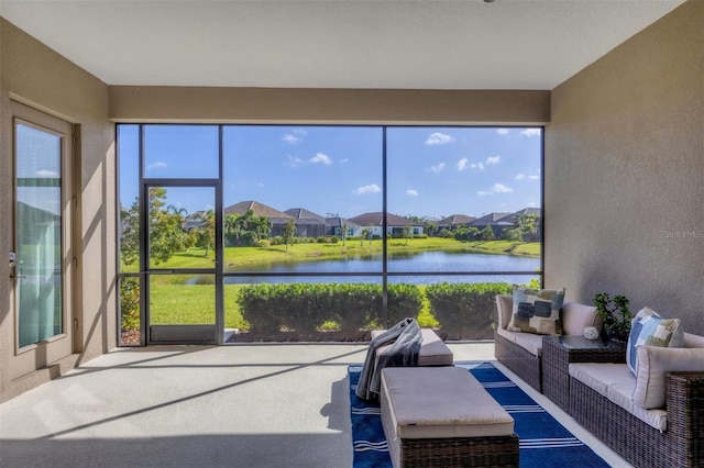 sunroom / solarium with a water view and a healthy amount of sunlight