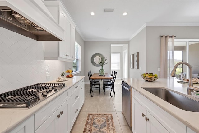 kitchen featuring stainless steel appliances, custom range hood, light tile patterned floors, sink, and white cabinets