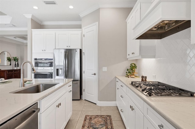 kitchen with stainless steel appliances, sink, crown molding, backsplash, and premium range hood