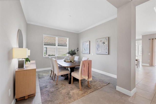 dining area featuring ornamental molding and light tile patterned floors