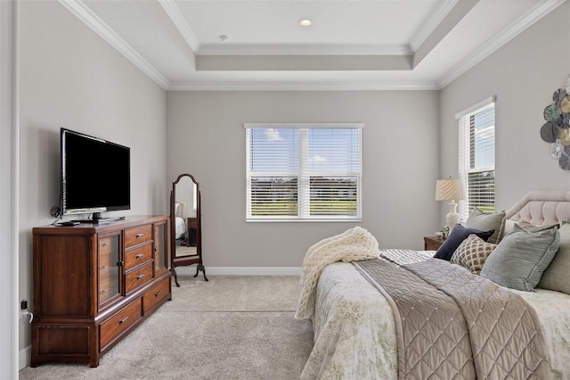 carpeted bedroom featuring a raised ceiling and ornamental molding