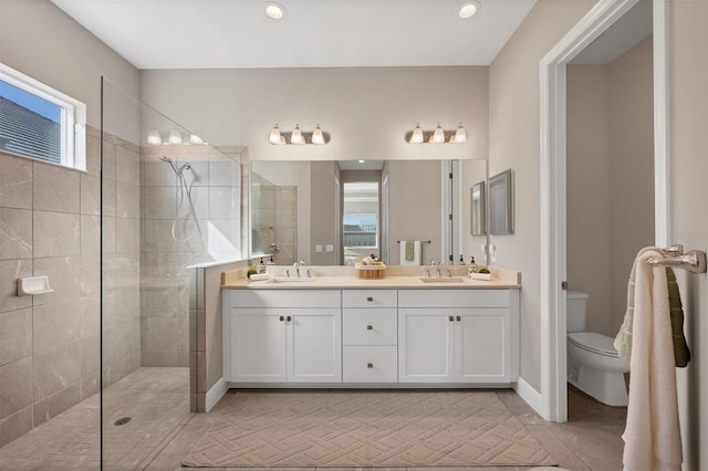 bathroom featuring plenty of natural light, tiled shower, and toilet