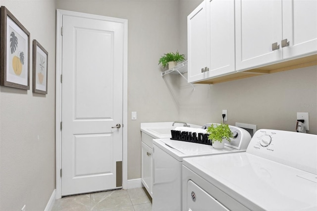 washroom featuring cabinets, light tile patterned flooring, washer and dryer, and sink