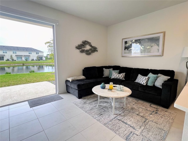 tiled living room featuring a water view