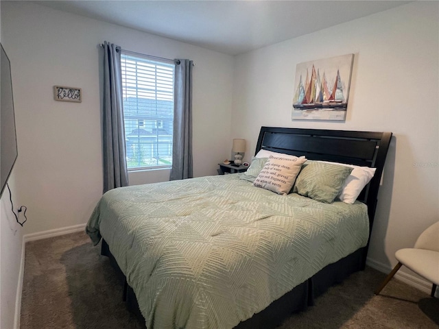 bedroom featuring carpet and baseboards