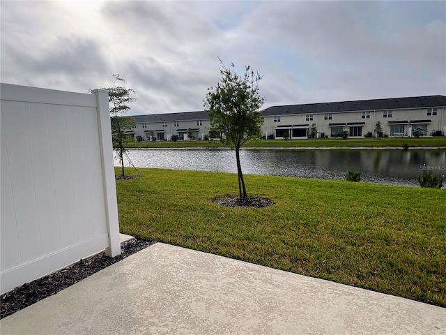 view of yard with a water view and a residential view