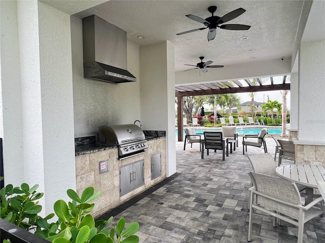 view of patio / terrace with a ceiling fan, an outdoor kitchen, area for grilling, and a community pool