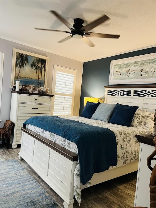 bedroom featuring dark wood-type flooring, ceiling fan, and ornamental molding