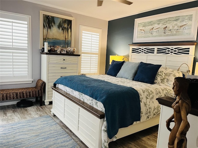 bedroom featuring hardwood / wood-style flooring, ceiling fan, and ornamental molding