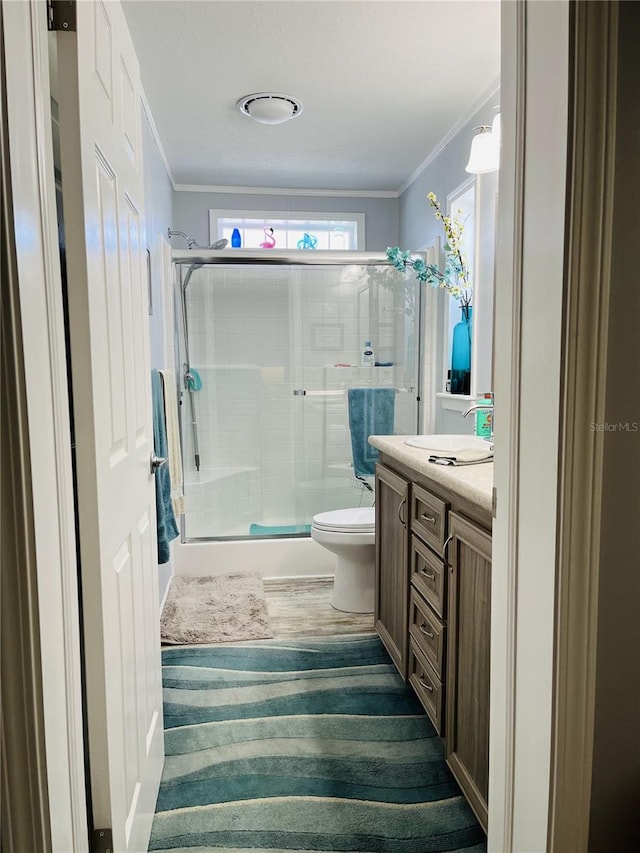 bathroom featuring toilet, vanity, and walk in shower