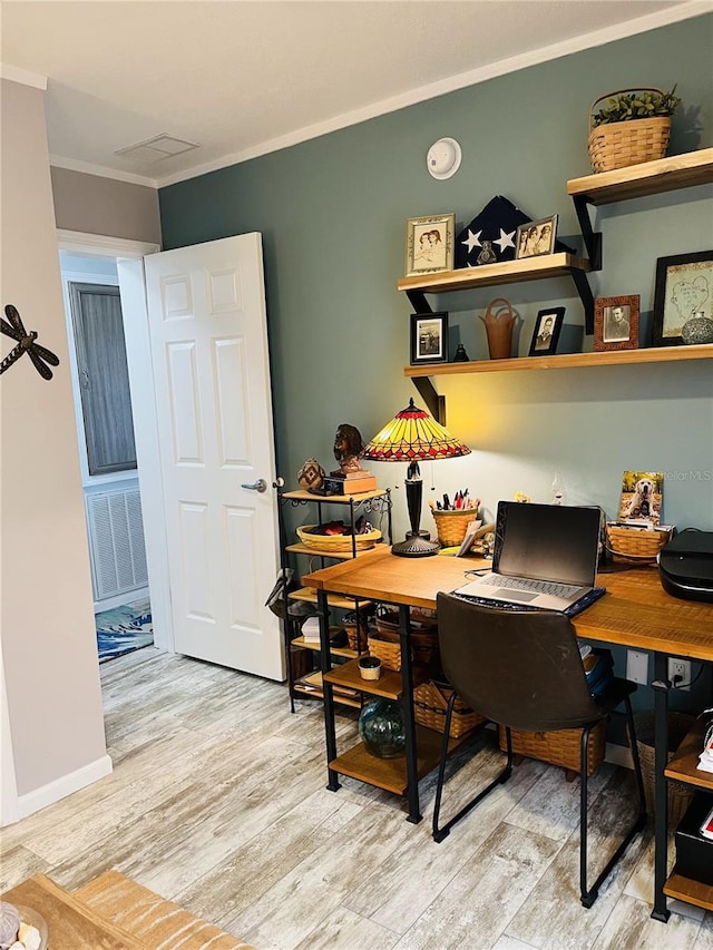 home office featuring light wood-type flooring and ornamental molding