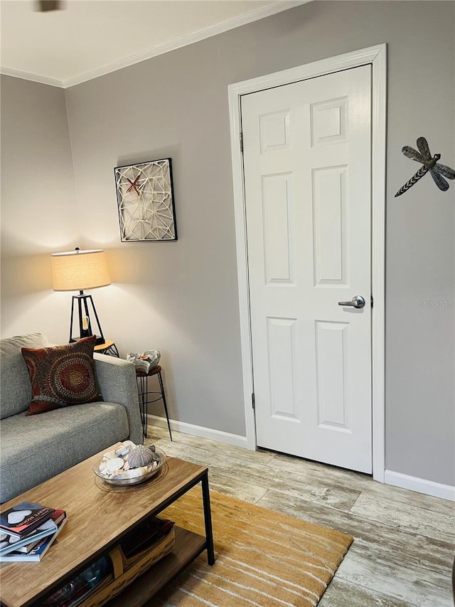 living room featuring hardwood / wood-style floors and crown molding