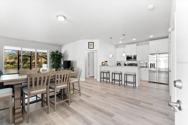 dining space featuring light wood-type flooring