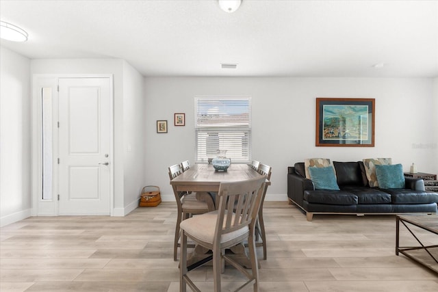 dining space with light hardwood / wood-style flooring