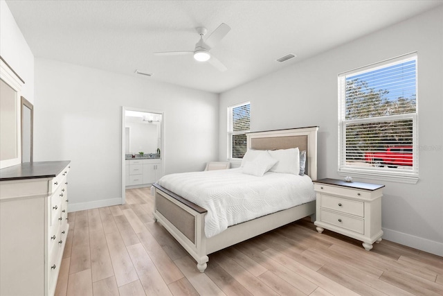 bedroom with ceiling fan, multiple windows, and light hardwood / wood-style floors