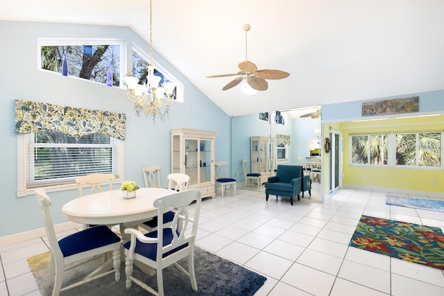 tiled dining room featuring high vaulted ceiling and ceiling fan with notable chandelier